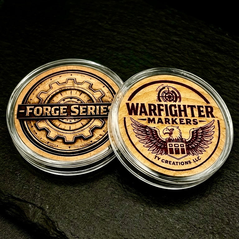 Two Warfighter Markers containers with 'Forge Series' and 'Warfighter Markers' branding engraved on wood coins on a dark background.