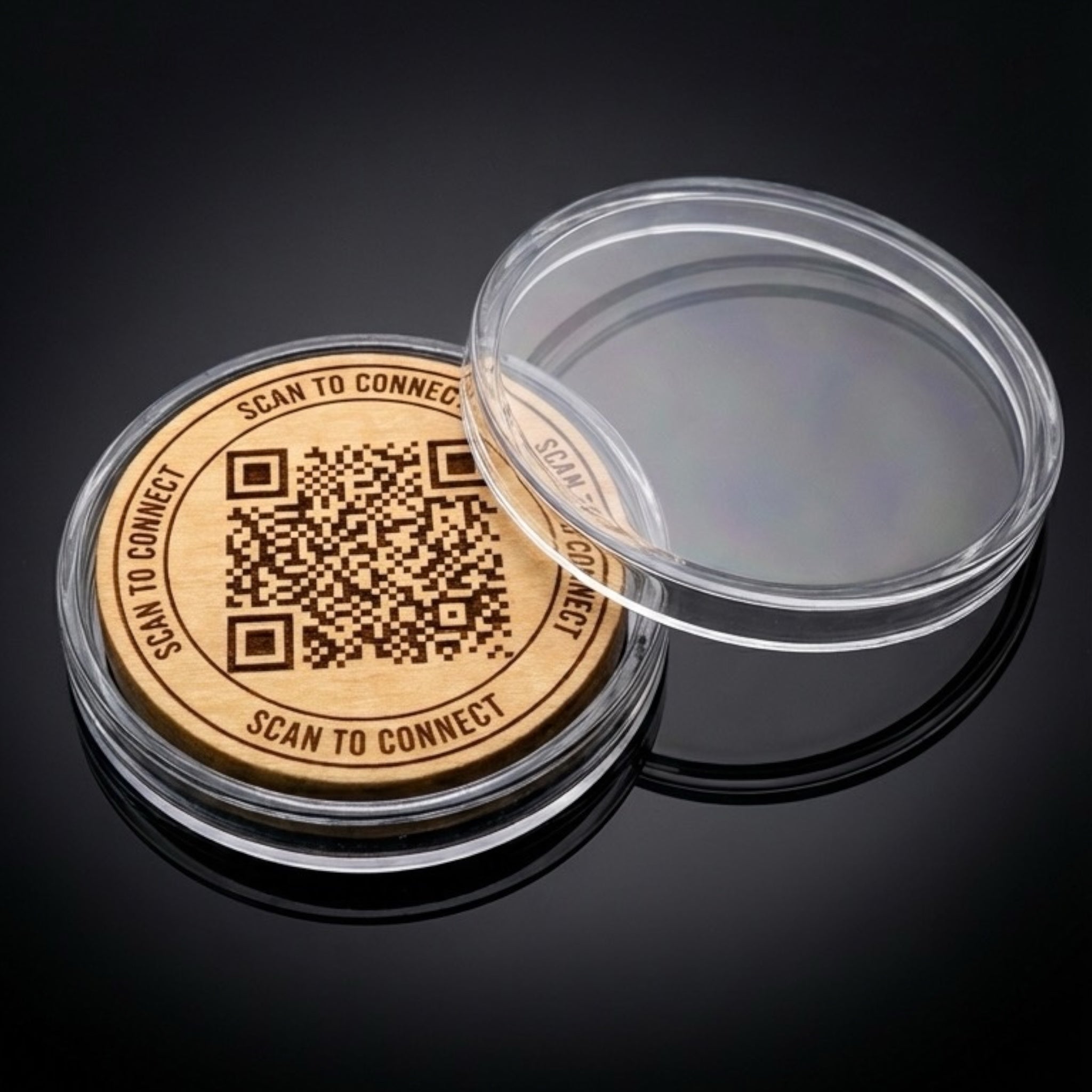 wood marker with QR code and 'Scan to Connect' text, inside an open clear acrylic capsule on a black background.